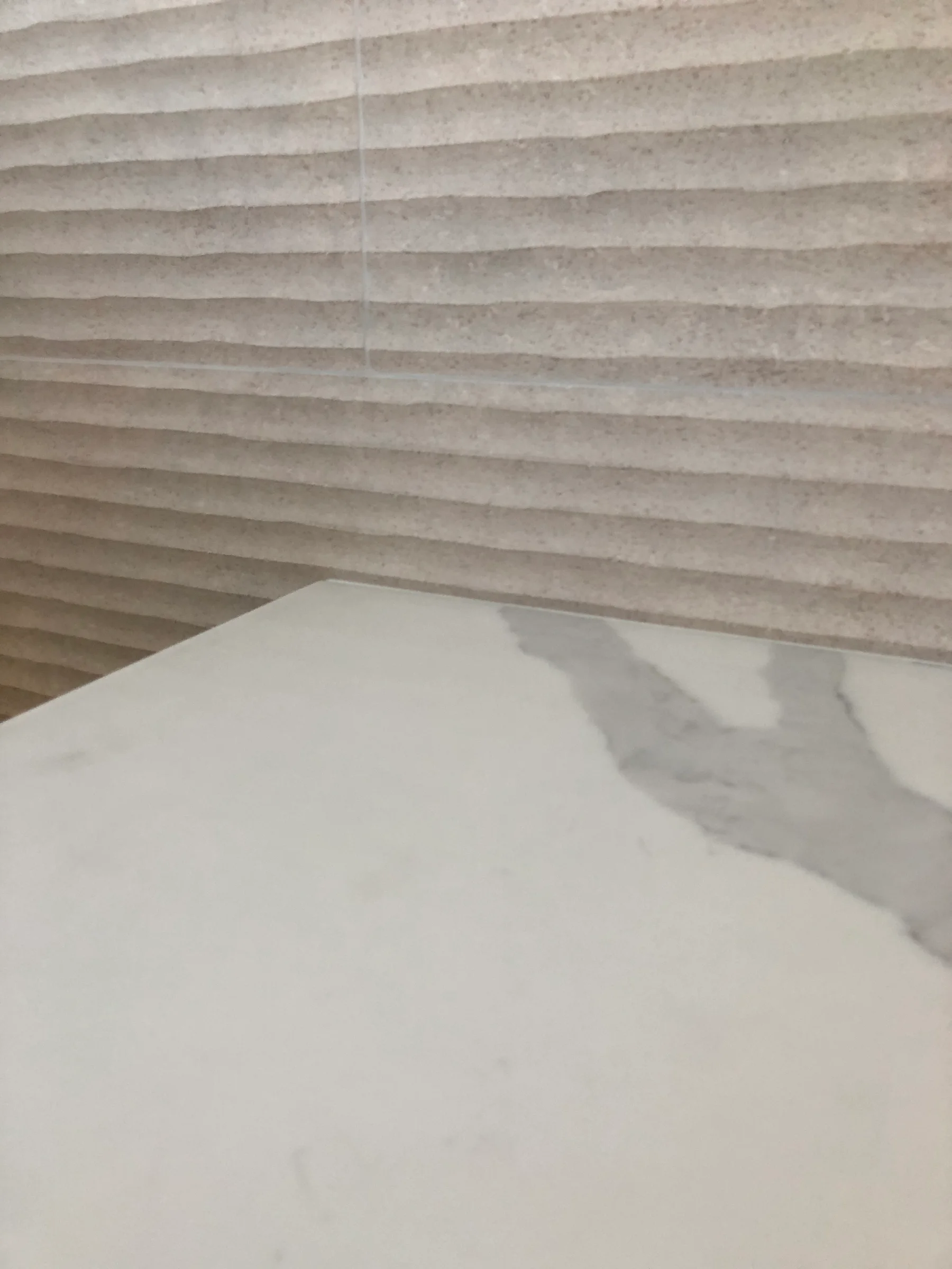 Neutral stone slab and textured wall-covering samples