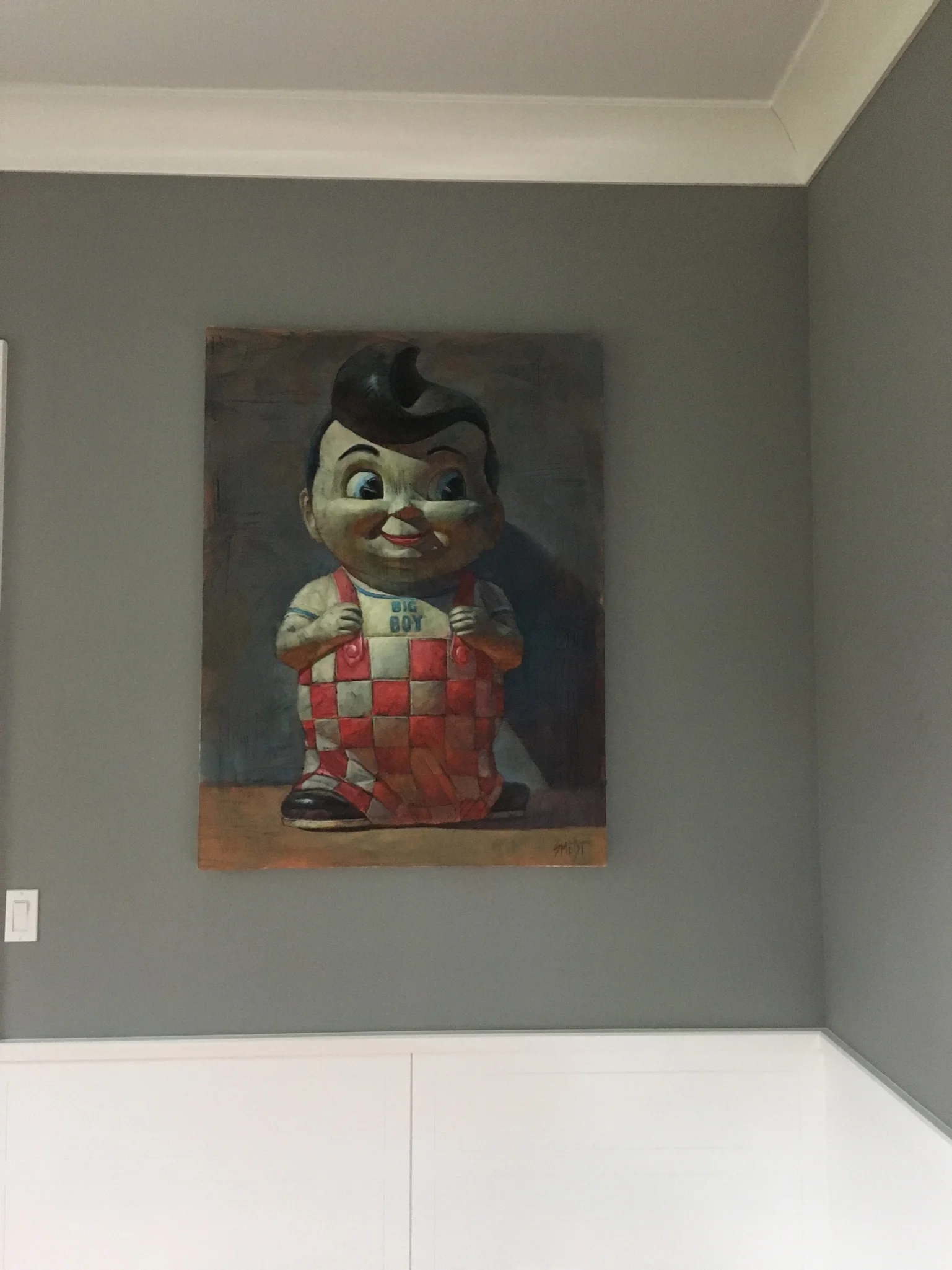 Vintage figure painting displayed on a soft gray wall