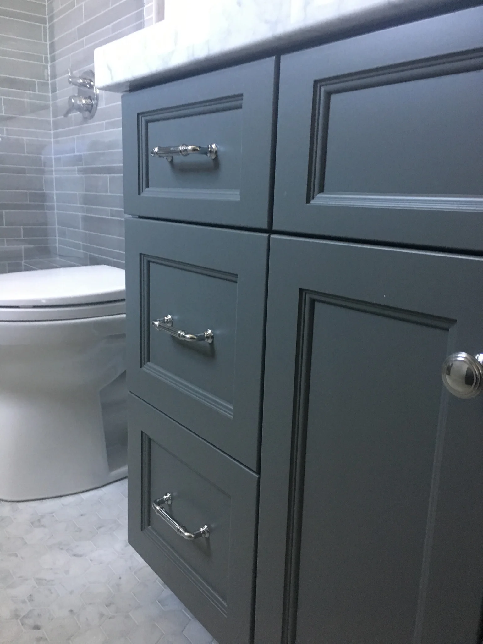 Deep blue bathroom cabinetry with polished silver hardware